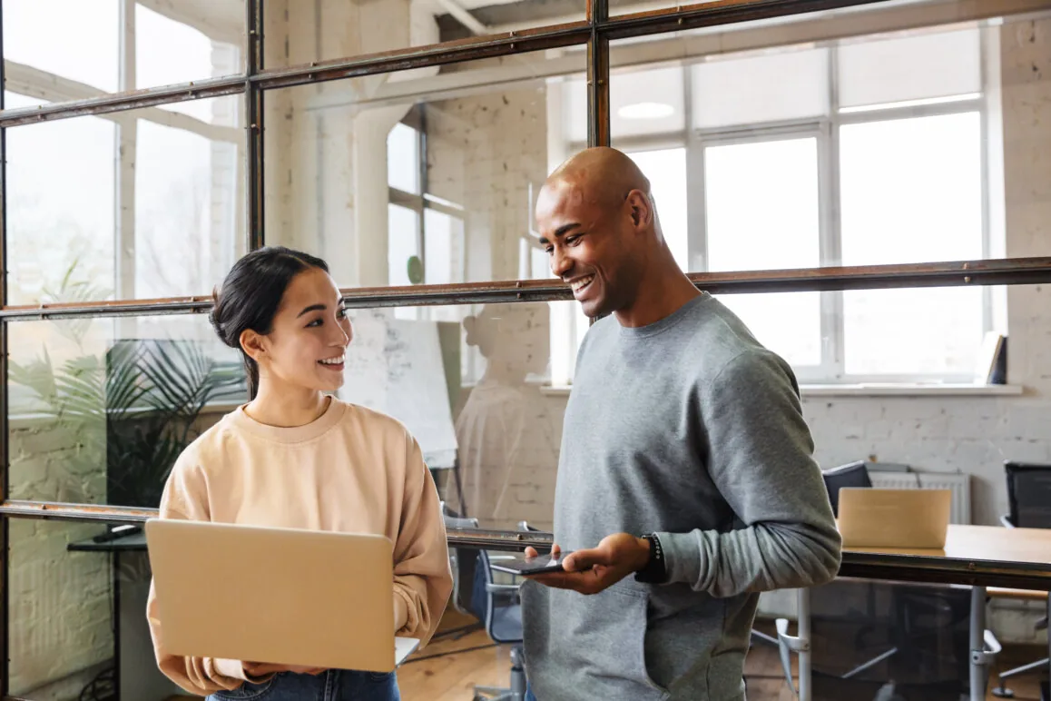 Young couple managing finances on laptop.